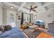Spacious living room with hardwood floors, a comfortable seating arrangement, and abundant natural light from large windows at 2677 Sardis Chase Ct, Buford, GA 30519