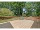 Wooden back deck with table and chairs overlooking a lush, green yard at 502 Allen Dr, Lawrenceville, GA 30043