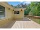Large wooden back deck on a bright yellow home surrounded by green trees at 502 Allen Dr, Lawrenceville, GA 30043