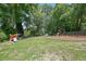 Large backyard with mature trees and playground equipment, great for Gathering fun at 502 Allen Dr, Lawrenceville, GA 30043