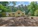 Large backyard with a shed, deck, fire pit and surrounded by mature trees at 502 Allen Dr, Lawrenceville, GA 30043
