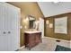 Bathroom with a vintage vanity, ample storage, and a window with a view at 502 Allen Dr, Lawrenceville, GA 30043