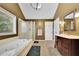 Bright bathroom features a soaking tub, glass shower, and stylish vanity at 502 Allen Dr, Lawrenceville, GA 30043