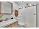 Modern bathroom featuring a glass-enclosed shower, stylish vanity, and decorative accents at 502 Allen Dr, Lawrenceville, GA 30043