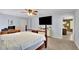 Bedroom featuring a four-poster bed, a ceiling fan, and a view into the adjacent bathroom at 502 Allen Dr, Lawrenceville, GA 30043