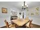 Elegant dining room featuring classic decor, wainscoting, and an adjacent living area at 502 Allen Dr, Lawrenceville, GA 30043