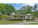 Inviting single-story home featuring a cozy front porch and mature landscaping at 502 Allen Dr, Lawrenceville, GA 30043