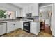 Bright kitchen with white cabinets, stainless steel appliances, and a view into the adjacent dining area at 502 Allen Dr, Lawrenceville, GA 30043