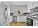 Charming kitchen featuring stainless steel appliances, white cabinetry, and a window with a view of the outdoors at 502 Allen Dr, Lawrenceville, GA 30043