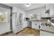 Well-lit kitchen featuring stainless steel appliances, white cabinets, and an exterior door at 502 Allen Dr, Lawrenceville, GA 30043
