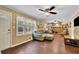 Comfortable living room featuring hardwood floors, bright windows, and a cozy seating area at 502 Allen Dr, Lawrenceville, GA 30043