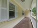 Charming porch with white railing and columns on a yellow house exterior at 502 Allen Dr, Lawrenceville, GA 30043