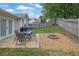 A spacious backyard with a well-maintained lawn, patio seating, and a fire pit area, great for outdoor living at 507 Hillcrest Cross Rd, Canton, GA 30115