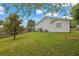 A well-maintained backyard with a lush lawn, wooden fence, and some greenery at 507 Hillcrest Cross Rd, Canton, GA 30115