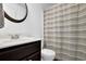 Clean bathroom with a vanity, round mirror, and a neutral-toned shower curtain at 507 Hillcrest Cross Rd, Canton, GA 30115