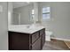 Bright bathroom featuring dark cabinets, a white sink, and natural light from a window at 507 Hillcrest Cross Rd, Canton, GA 30115