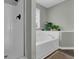 Bathroom featuring a soaking tub, shower, silver faucet, and natural light from a window at 507 Hillcrest Cross Rd, Canton, GA 30115