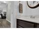 Cozy half bathroom with a dark wood vanity, round mirror, and light-colored walls at 507 Hillcrest Cross Rd, Canton, GA 30115
