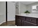 Bathroom boasting a dark vanity, a white countertop, a closet, and warm wooden floors at 507 Hillcrest Cross Rd, Canton, GA 30115