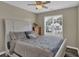 Bedroom with a decorative headboard, window, dresser and ceiling fan at 507 Hillcrest Cross Rd, Canton, GA 30115