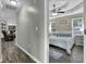 Comfortable bedroom featuring a king-sized bed, tray ceiling, and an adjacent living space at 507 Hillcrest Cross Rd, Canton, GA 30115