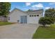 A single-car garage with white door and blue side entrance, complemented by a paved driveway at 507 Hillcrest Cross Rd, Canton, GA 30115