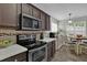 Contemporary kitchen featuring stainless steel appliances, dark wood cabinets and a breakfast nook at 507 Hillcrest Cross Rd, Canton, GA 30115