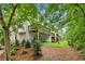 Beautiful backyard view with mature trees, a small patio, and well-maintained landscaping at 1036 Grant Park Rd, Decatur, GA 30033