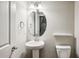 Half bath with pedestal sink and brushed nickel accents at 1036 Grant Park Rd, Decatur, GA 30033