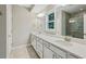 Bright bathroom with a double vanity, white cabinets, and tiled shower behind a glass door at 1036 Grant Park Rd, Decatur, GA 30033