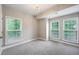 This bedroom has carpeted floors, a chandelier, and multiple windows at 1036 Grant Park Rd, Decatur, GA 30033