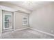 This bedroom has carpeted floors, a chandelier, and two windows at 1036 Grant Park Rd, Decatur, GA 30033