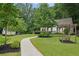 Exterior view of the clubhouse with a beautiful garden area and a covered bench at 1036 Grant Park Rd, Decatur, GA 30033