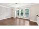 Dining area with modern light fixture and gleaming wood floors at 1036 Grant Park Rd, Decatur, GA 30033