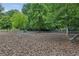 Community dog park, a fun and safe area for pets to play with mulch ground and a bench at 1036 Grant Park Rd, Decatur, GA 30033