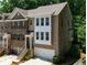 Exterior view of a brick townhome with a two-car garage and well-manicured landscaping at 1036 Grant Park Rd, Decatur, GA 30033