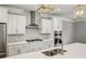 Modern kitchen with white cabinets, stainless steel appliances, and herringbone backsplash at 1036 Grant Park Rd, Decatur, GA 30033