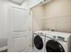 Bright laundry room with a modern washer and dryer, and ample shelving for storage at 1036 Grant Park Rd, Decatur, GA 30033