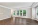 Spacious living room with hardwood floors and natural light from large windows at 1036 Grant Park Rd, Decatur, GA 30033