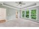 This main bedroom has a ceiling fan, multiple windows that let in plenty of natural light, and an adjacent bathroom at 1036 Grant Park Rd, Decatur, GA 30033