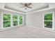 This main bedroom features a ceiling fan and multiple windows that let in plenty of natural light at 1036 Grant Park Rd, Decatur, GA 30033