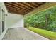 Covered patio overlooking a lush backyard with mature trees and green lawn at 1036 Grant Park Rd, Decatur, GA 30033
