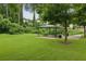 Outdoor picnic area featuring covered tables surrounded by greenery and a grass lawn at 1036 Grant Park Rd, Decatur, GA 30033