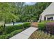 Outdoor pool deck area with hedges, lounge chairs and a view of the forest at 1036 Grant Park Rd, Decatur, GA 30033