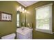 Bathroom featuring a white vanity, framed mirror with lighting, and a neutral color scheme at 1777 Chasewood Park Ln, Marietta, GA 30066
