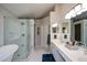 Modern bathroom featuring double sinks, a glass-enclosed shower, and a luxurious soaking tub at 1777 Chasewood Park Ln, Marietta, GA 30066
