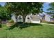 Landscaped front yard with green lawn and mature tree shading the two-story home at 1777 Chasewood Park Ln, Marietta, GA 30066