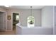 Upstairs hallway with decorative chandelier and view into bedroom featuring a decorative window at 1777 Chasewood Park Ln, Marietta, GA 30066