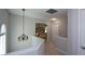 Upstairs hallway offers views into a bedroom with tray ceiling and decorative lighting fixture at 1777 Chasewood Park Ln, Marietta, GA 30066