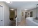 Upstairs hallway with a decorative chandelier, neutral walls, and access to multiple rooms at 1777 Chasewood Park Ln, Marietta, GA 30066